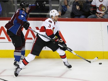Ottawa Senators defenseman Marc Methot, right, tries to clear the puck as he gets tangled up with the stick of Colorado Avalanche center Matt Duchene during the first period of an NHL hockey game Wednesday, Nov. 25, 2015, in Denver.