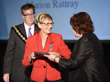 Marion Rattray receives the Order of Ottawa from Mayor Jim Watson and Councillor Jan Harder at City Hall in Ottawa on Tuesday, November 10, 2015.