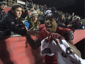 Ottawa Redblacks' wide receiver Maurice Price celebrates with fans after the Redblacks beat the Hamilton Tiger-Cats, in Ottawa, on Nov. 7.