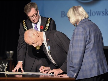 Mayor Jim Watson and Councillor Marianne Wilkinson look on as philanthropist and municipal leader Ben Babelowsky receives the Order of Ottawa.