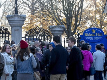 Members of the public wait at the gates of Rideau Hall before the swearing-in ceremony of Prime Minister-designate Justin Trudeau in Ottawa on Wednesday, Nov. 4, 2015.