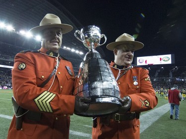 Members of the RCMP carry the Grey Cup off the field during opening ceremony for the 103rd Grey Cup in Winnipeg, Man. Sunday, Nov. 29, 2015.
