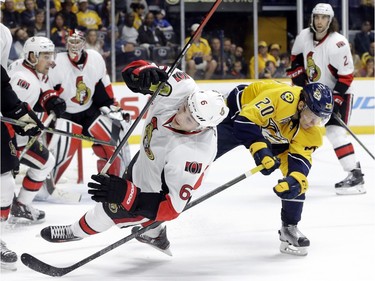 Nashville Predators forward Miikka Salomaki (20) collides with Ottawa Senators right wing Bobby Ryan (6) in the second period of an NHL hockey game Tuesday, Nov. 10, 2015, in Nashville, Tenn. Salomaki was penalized for tripping on the play.