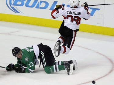 Ottawa Senators center Mika Zibanejad (93) jumps over Dallas Stars center Mattias Janmark (13) as they battle for the puck during the first period.