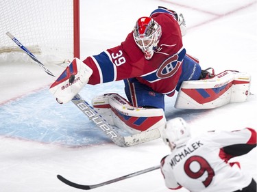 Montreal Canadiens' goalie Mike Condon deflects a shot from Ottawa Senators' Milan Michalek off his blocker during second period NHL action.