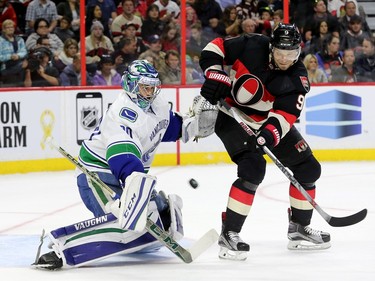 Milan Michalek tries to get the puck past Vancouver goalie, Ryan Miller, during first period action.