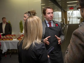 Treasury Board President Scott Brison, seen here serving doughnuts to public servants soon after the Liberals took power, is trying to repair relations with the public service. But a tough round of bargaining looms.