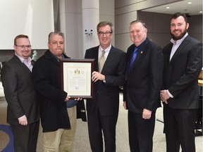 Mayor Jim Watson presents Aldege Bellefeuille with a Mayor's City Builder Award.