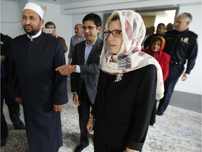 Ontario Premier Kathleen Wynne, right, is joined by Imam Samy Metwally, left, and Ottawa Centre MPP Yasir Naqvi, center, as she visits the Ottawa Main Mosque Friday November 20, 2015. (Darren Brown/Ottawa Citizen)