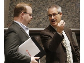 Ottawa city councillor and transit commission chair Stephen Blais, left, chats with Coun. Keith Egli before the city's 2016 draft budget is tabled at Ottawa City Hall Thursday November 12, 2015. (Darren Brown/Ottawa Citizen)