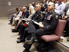 Ottawa Police Chief Charles Bordeleau, right, looks on during the city's 2016 draft budget in Ottawa City Hall council chambers Thursday November 12, 2015. (Darren Brown/Ottawa Citizen)