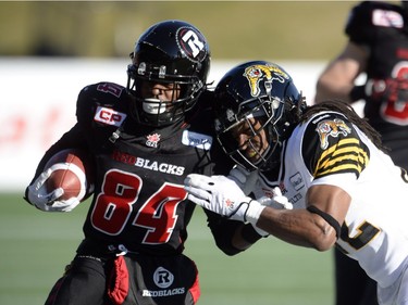 Ottawa Redblacks wide receiver Jamill Smith is tackled by Hamilton Tiger-Cats defensive back Courtney Stephen during first half action in the CFL East Division final in Ottawa, Sunday November 22, 2015.