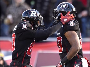 Ottawa Redblacks's Chris Williams, left, and William Powell celebrate Powell's touchdown against the Hamilton Tiger-Cats during first half action in the CFL East Division final in Ottawa, Sunday November 22, 2015.