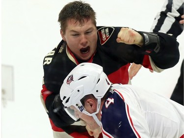 Ottawa Senators' Curtis Lazar (27) fights with Columbus Blue Jackets' Kevin Connauton (4) during first period NHL hockey action in Ottawa Thursday, November 19, 2015.