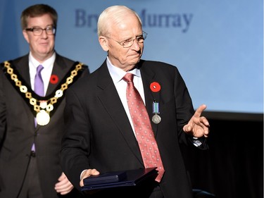 Ottawa Senators General Manager Bryan Murray waves to onlookers after receiving the Order of Ottawa from Mayor Jim Watson.