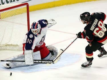 Ottawa Senators' Mike Hoffman (68) is stopped by Columbus Blue Jackets goalie Curtis McElhinney (30) as he takes a penalty shot during first period NHL hockey action in Ottawa Thursday, November 19, 2015.