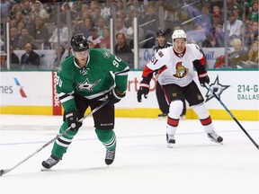 Jason Spezza #90 of the Dallas Stars controls the puck against Mark Stone #61 of the Ottawa Senators in the first period at American Airlines Center on November 24, 2015 in Dallas, Texas.