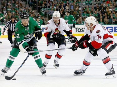 Colton Sceviour #22 of the Dallas Stars controls the puck against Mark Borowiecki #74 of the Ottawa Senators and Milan Michalek #9 of the Ottawa Senators in the first period at American Airlines Center on November 24, 2015 in Dallas, Texas.