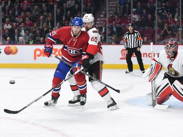 Lars Eller #81 of the Montreal Canadiens attempts to deflect the puck against Craig Anderson #41of the Ottawa Senators .