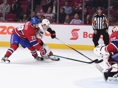 Alex Chiasson #90  of the Ottawa Senators controls the puck against Nathan Beaulieu #28  of the Montreal Canadiens.