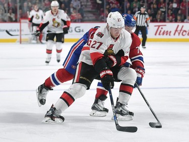 Curtis Lazar #27 of the Ottawa Senators controls the puck against Andrei Markov #79 of the Montreal Canadiens.