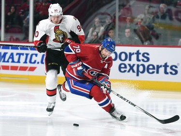 Andrei Markov #79 of the Montreal Canadiens tries to keep the puck from Alex Chiasson #90 of the Ottawa Senators.