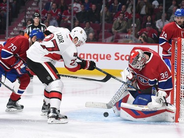Mike Condon #39 of the Montreal Canadiens blocks the shot by Curtis Lazar #27 of the Ottawa Senators.