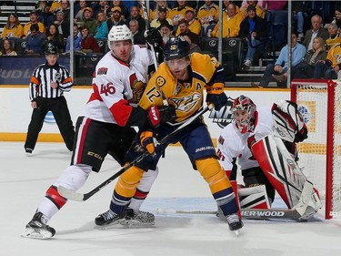 Patrick Wiercioch #46 of the Ottawa Senators ties up Mike Fisher #12 of the Nashville Predators during the first period.