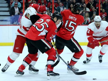 Ottawa's Chris Neil takes the puck as Zack Smith gets caught up during first period action between the Ottawa Senators and Detroit  Red Wings Monday (Nov 16, 2015) at Canadian Tire Centre.