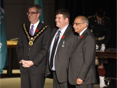 Paul Meek receives the Order of Ottawa from Mayor Jim Watson and Councillor Shad Qadri at City Hall in Ottawa on Tuesday, November 10, 2015.