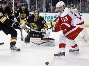 The Detroit Red Wings' Pavel Datsyuk goes for the puck beside the net of Boston Bruins goalie Tuukka Rask on Saturday, Nov. 14, 2915 in his second game back following offseason ankle surgery.