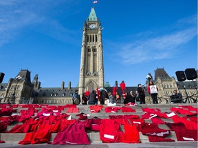 People from Ottawa and Gatineau's indigenous community and their supporters leave red dresses representing missing and murdered women on the steps of Parliament Hill while taking part in a rally in support of women in Val-d'Or, Que., who allege abuse at the hands of provincial police officers. November 3.