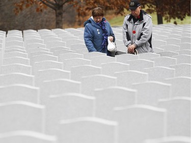 People pay their respects after the Remembrance Day ceremony at the National Military Cemetery on the grounds of the Beechwood Cemetery Wednesday November 11, 2015.