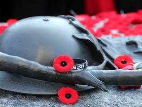 Poppies are placed on the Tomb of the Unknown Soldier after the ceremony. Remembrance Day at the National War Memorial in Ottawa.