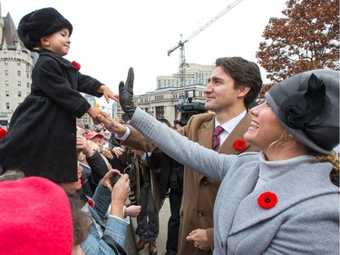 Prime Minister Justin Trudeau and his wife  Sophie Grégoire-Trudeau greet Niamh Barr, 2, following the march past as the National Remembrance Day Ceremony takes place at the National War Memorial in Ottawa.