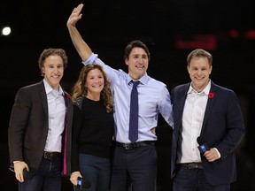 Prime Minister Justin Trudeau and his wife, Sophie, are flanked by We Day co-founders, Craig Kielburger, left, and his brother Marc, right, in front of a crowd of 16,000 people  during the We Day event at the Canadian Tire Centre in Ottawa Tuesday November 10, 2015.