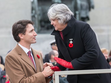 Prime Minister Justin Trudeau chats with Sheila Anderson, the 2015 Silver Cross Mother, while waiting for the march past to begin as the National Remembrance Day Ceremony takes place at the National War Memorial in Ottawa.