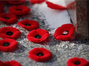 Poppies are placed on a cenotaph during a Remembrance Day service in Winnipeg, Tuesday, November 11, 2014.