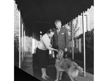 Rt.Hon. John George Diefenbaker, Prime Minister of Canada, and Mrs. Olive Diefenbaker with pet dog on door step of official residence, 24 Sussex Drive.  October 1962