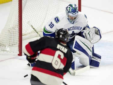 Ottawa Senators right wing Bobby Ryan shoots on Vancouver Canucks goalie Ryan Miller during first period NHL action.