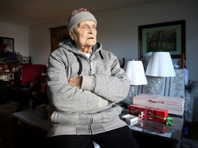 Sam Severenuk, 83, wears his tuque and heavy sweater inside his unit at The Claridge on Carling Avenue. Crews have been updating the heating system at the apartment building since late July and the heat still isn't working.