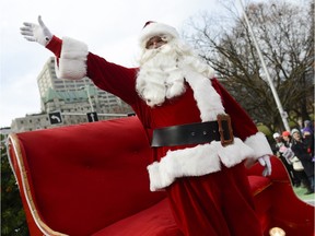 Santa Claus waves at the crowd and remind children to be good because he is watching during the 46th annual Help Santa Toy Parade which took place in Ottawa on Saturday, Nov. 21, 2015.