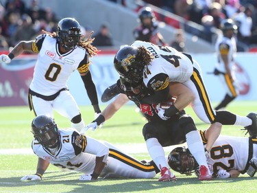 Scott Macdonell of the Ottawa Redblacks is tackled by #44 Taylor Reed of the Hamilton Tiger-Cats during first half of the East Conference finals at TD Place in Ottawa, November 22, 2015. (Jean Levac/ Ottawa Citizen)