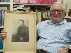 Second World War veteran Robert Spencer, 95, holds a photo of himself as a young soldier.