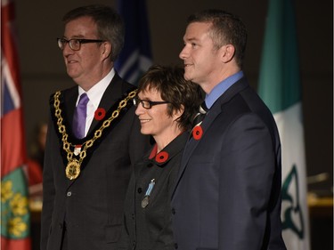 Simone Thibault receives the Order of Ottawa from Mayor Jim Watson and Councillor Tim Tierney at City Hall in Ottawa on Tuesday, November 10, 2015.