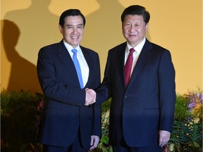 Chinese President Xi Jinping (R) shakes hands with Taiwan President Ma Ying-jeou (L) before their meeting at Shangrila hotel in Singapore on November 7, 2015. The leaders of China and Taiwan hold a historic summit that will put a once unthinkable presidential seal on warming ties between the former Cold War rivals.