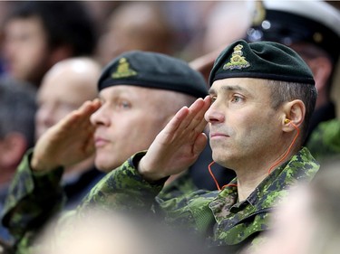 Soldiers salute during the national anthem.