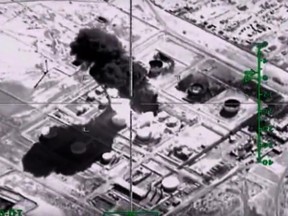 A video grab made on November 18, 2015, shows an image taken from a footage made available on the Russian Defence Ministry's official website on November 18, 2015, purporting to show an explosion after airstrikes carried out by Russian air force on what Russia says was an Islamic State oil-processing facility at an unidentified location in Syria.