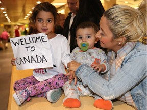 Syrian refugees are welcomed by family and supporters as the first group of refugees arrived at the Calgary Airport in Calgary on Monday November 23, 2015.
