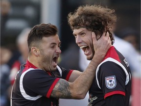 The Ottawa Fury's Tom Heinemann, right, celebrates with teammate Sinisa Ubiparipovic after scoring the Fury's first goal against the Minnesota United during second half action at TD Place in Ottawa on Sunday, Nov. 8, 2015.